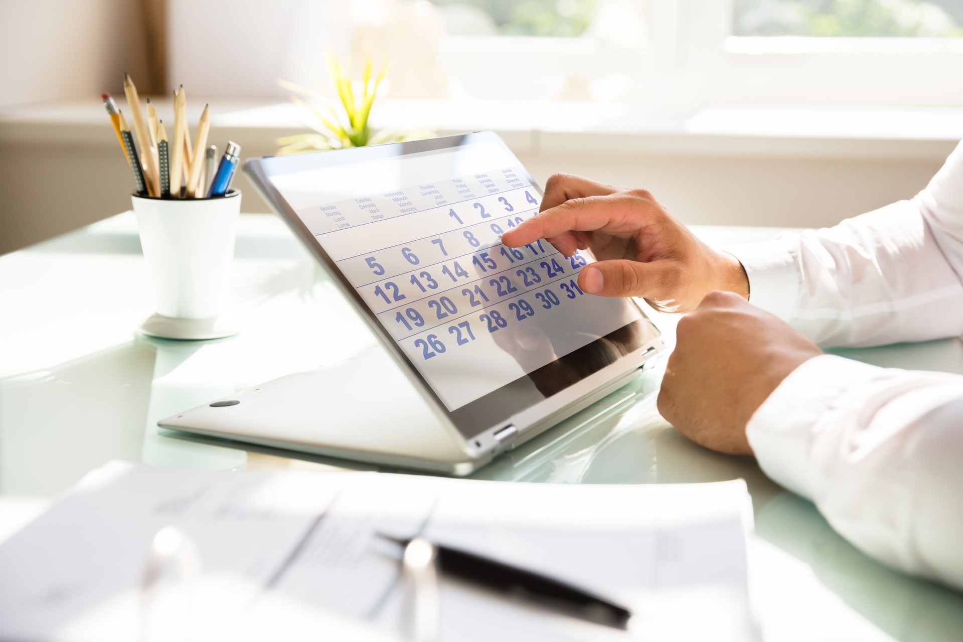 Businessman using calendar on laptop